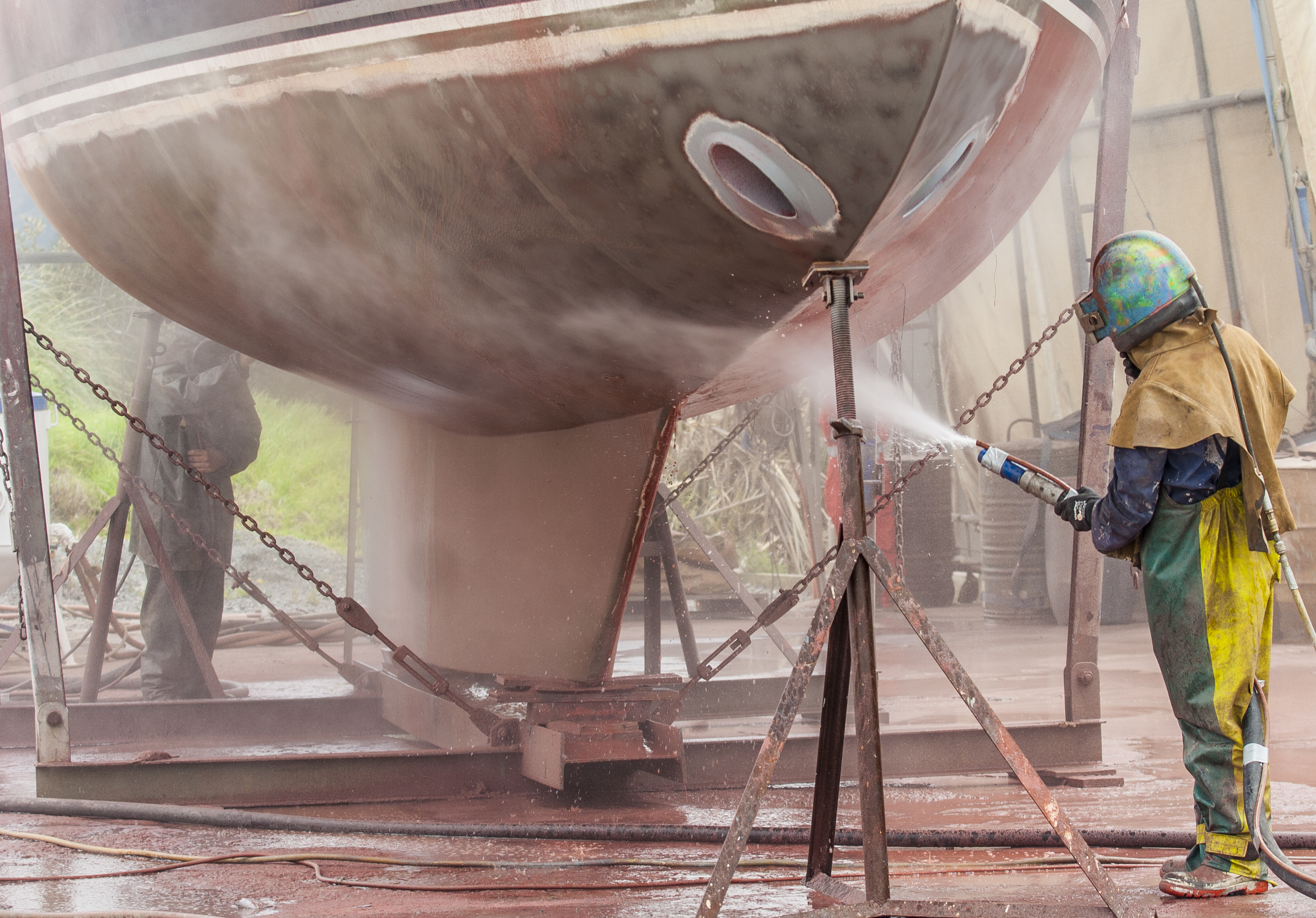 A person spraying a boat AI-generated content may be incorrect.